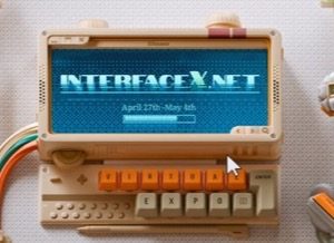 retro handheld device showing INTERFACEX.NET on its screen
